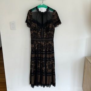 Tadashi Shoji black lace illusion neckline tea length dress - size 10